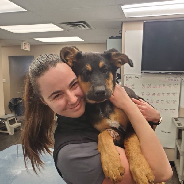 Tanis holding a puppy